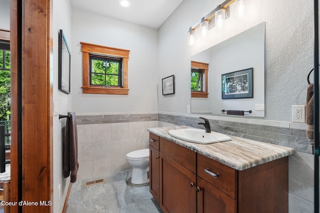 4127 Sagle Rd, Sagle, ID 83860 - bathroom featuring vanity, tile walls, wainscoting, and recessed lighting