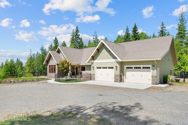 4127 Sagle Rd, Sagle, ID 83860 - craftsman inspired home featuring concrete driveway, stone siding, board and batten siding, an attached garage, and a shingled roof