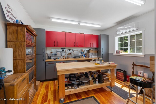 4127 Sagle Rd, Sagle, ID 83860 - kitchen featuring red cabinets, a wall unit AC, light wood-style floors, and wood counters