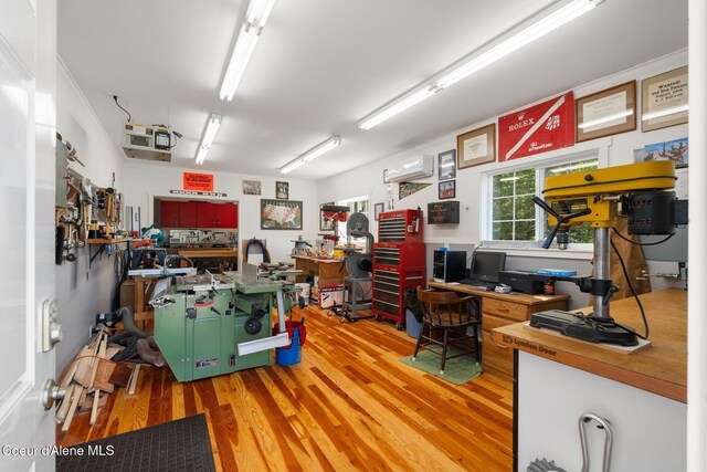 4127 Sagle Rd, Sagle, ID 83860 - home office with light wood finished floors, an AC wall unit, and a workshop area