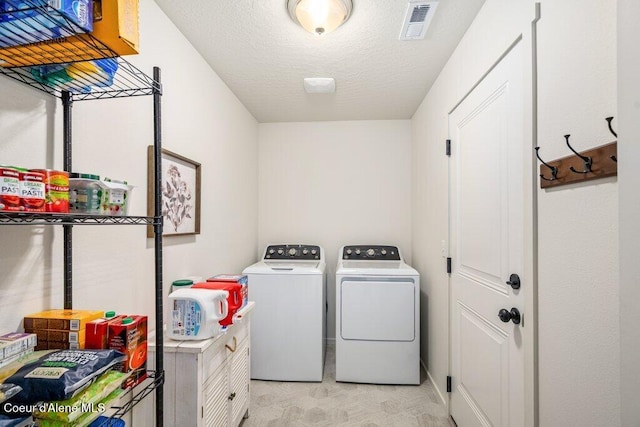 10514 N Liverpool Loop, Hayden, ID 83835 - laundry area with washer and dryer and a textured ceiling
