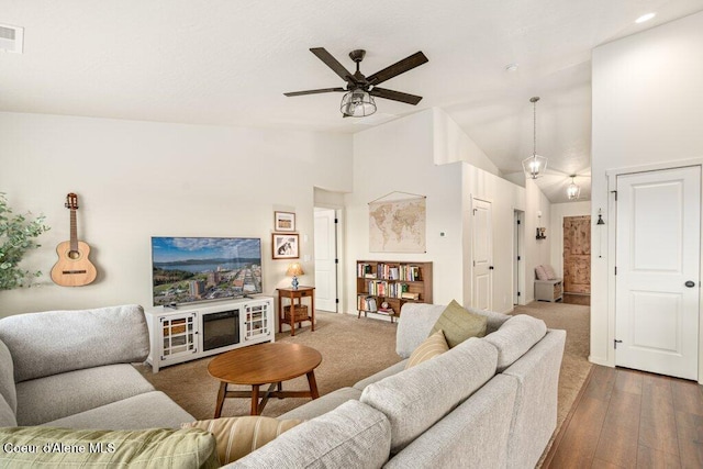 10514 N Liverpool Loop, Hayden, ID 83835 - living room featuring vaulted ceiling, ceiling fan, and wood finished floors