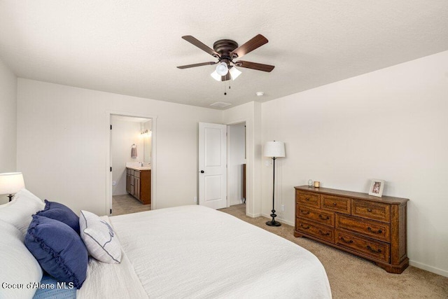 10514 N Liverpool Loop, Hayden, ID 83835 - bedroom with light carpet, ensuite bathroom, and a ceiling fan