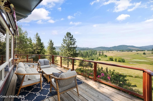 5143 W Crazy Creek Rd, Coeur Dalene, ID 83814 - wooden deck featuring a mountain view and an outdoor living space