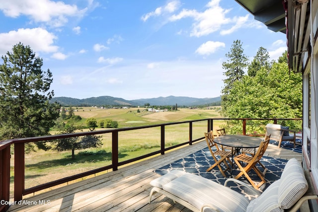 5143 W Crazy Creek Rd, Coeur Dalene, ID 83814 - wooden terrace with a mountain view and outdoor dining space