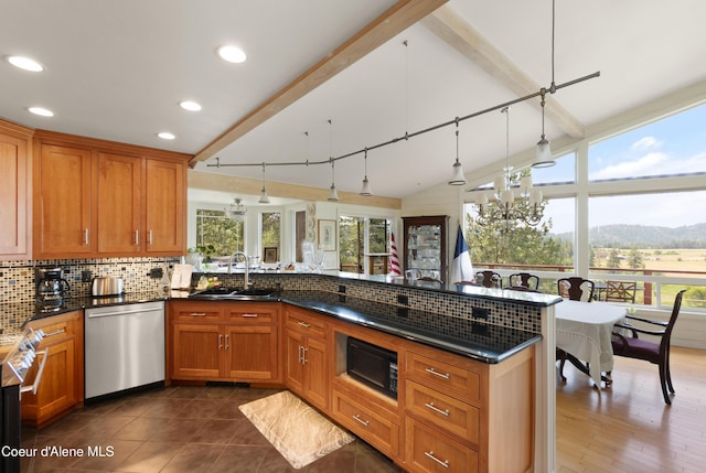 5143 W Crazy Creek Rd, Coeur Dalene, ID 83814 - kitchen with stainless steel dishwasher, a peninsula, healthy amount of natural light, decorative backsplash, and recessed lighting