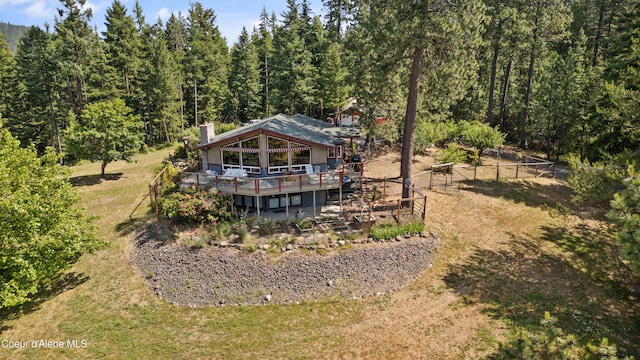 5143 W Crazy Creek Rd, Coeur Dalene, ID 83814 - rear view of property with a wooden deck, a chimney, and a wooded view