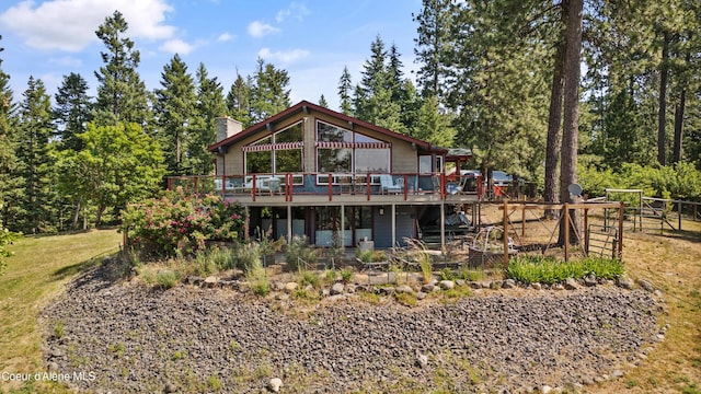 5143 W Crazy Creek Rd, Coeur Dalene, ID 83814 - rear view of property with a wooden deck and a chimney
