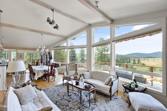 5143 W Crazy Creek Rd, Coeur Dalene, ID 83814 - sunroom with a chandelier, wood finished floors, and a mountain view