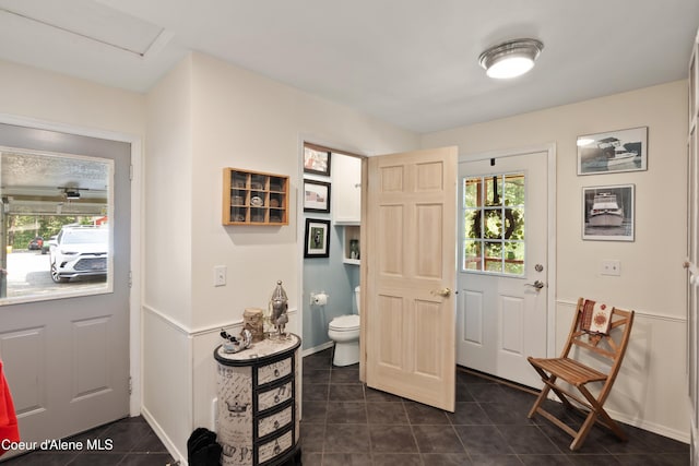 5143 W Crazy Creek Rd, Coeur Dalene, ID 83814 - foyer entrance featuring dark tile patterned floors and baseboards