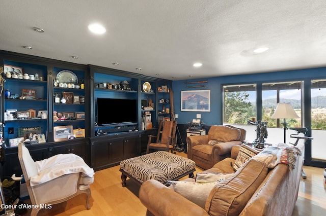 5143 W Crazy Creek Rd, Coeur Dalene, ID 83814 - living room featuring healthy amount of natural light, light wood-style floors, recessed lighting, and a textured ceiling