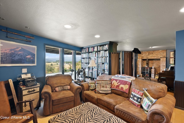5143 W Crazy Creek Rd, Coeur Dalene, ID 83814 - living area featuring a wood stove, a textured ceiling, recessed lighting, and wood finished floors
