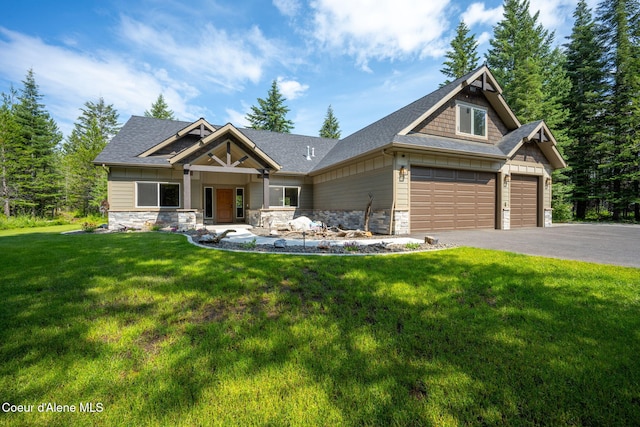 21315 N Eclipse Rd, Rathdrum, ID 83858 - craftsman-style home with stone siding, driveway, a front lawn, a shingled roof, and an attached garage