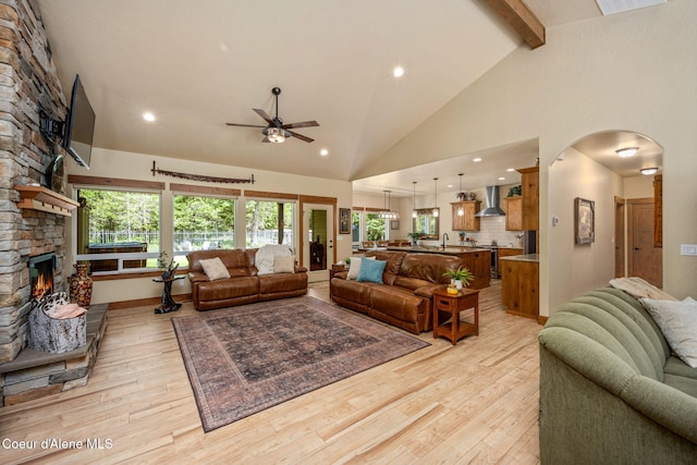 21315 N Eclipse Rd, Rathdrum, ID 83858 - living room featuring a stone fireplace, a ceiling fan, recessed lighting, light wood finished floors, and beam ceiling