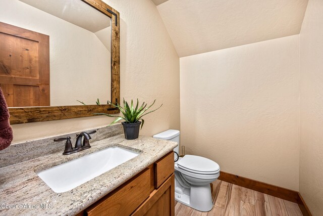 21315 N Eclipse Rd, Rathdrum, ID 83858 - half bathroom featuring lofted ceiling, wood finished floors, vanity, and a textured wall