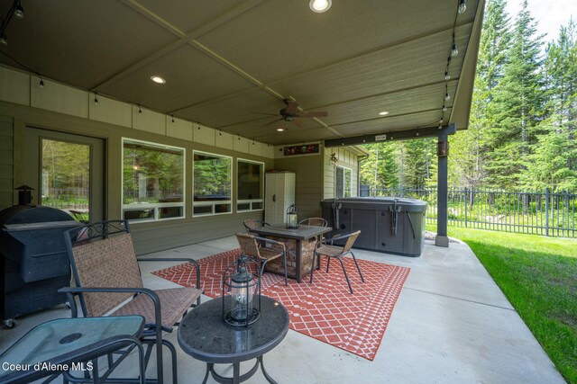 21315 N Eclipse Rd, Rathdrum, ID 83858 - view of patio / terrace with a hot tub, ceiling fan, outdoor dining area, and area for grilling