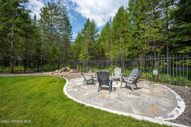 21315 N Eclipse Rd, Rathdrum, ID 83858 - fenced backyard featuring a patio and a view of trees