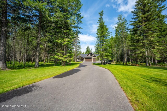 21315 N Eclipse Rd, Rathdrum, ID 83858 - view of asphalt driveway with a wooded view