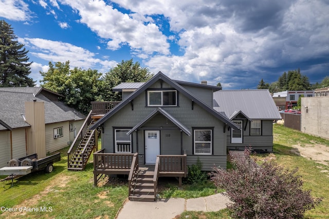 110 Cedar St, Priest River, ID 83856 - view of front facade with stairs, a metal roof, a deck, and a front yard