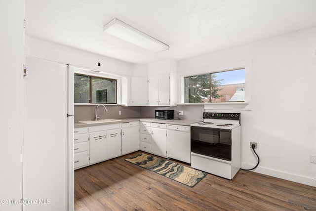 110 Cedar St, Priest River, ID 83856 - kitchen featuring white appliances, dark wood-type flooring, white cabinets, and healthy amount of natural light