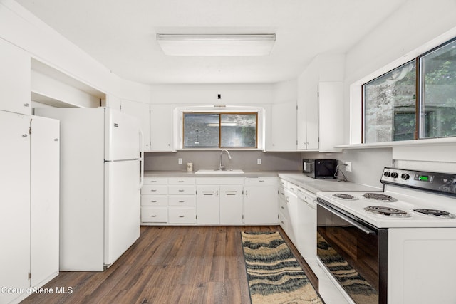 110 Cedar St, Priest River, ID 83856 - kitchen featuring white appliances, dark wood-style flooring, white cabinetry, and plenty of natural light