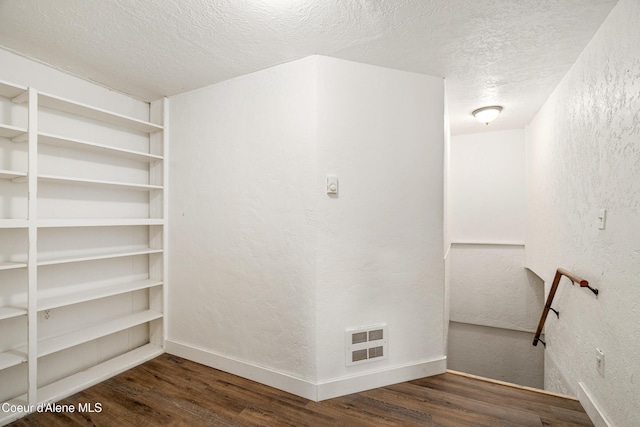 110 Cedar St, Priest River, ID 83856 - spare room with wood finished floors, a textured wall, and a textured ceiling
