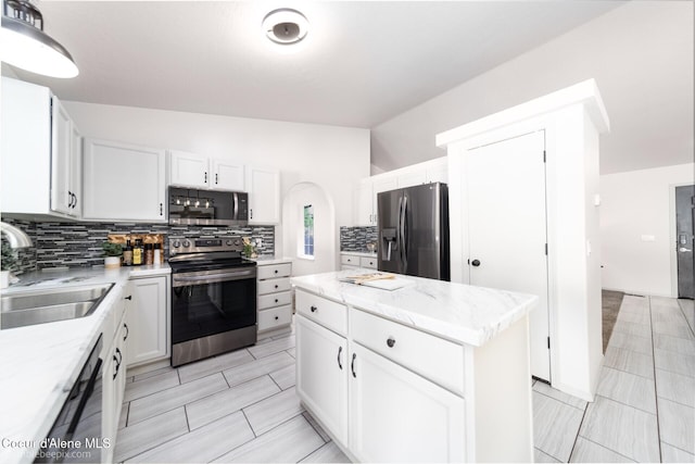 870 E Cloverleaf Dr, Hayden, ID 83835 - kitchen featuring stainless steel appliances, tasteful backsplash, a kitchen island, white cabinets, and light stone counters