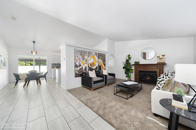 870 E Cloverleaf Dr, Hayden, ID 83835 - living area with vaulted ceiling, a warm lit fireplace, and arched walkways