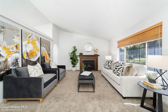 870 E Cloverleaf Dr, Hayden, ID 83835 - carpeted living room with vaulted ceiling and a warm lit fireplace