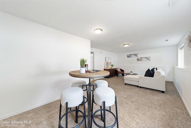 870 E Cloverleaf Dr, Hayden, ID 83835 - dining space with carpet and baseboards