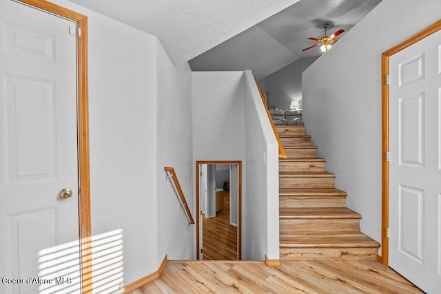 5735 E Steamboat Bnd, Post Falls, ID 83854 - staircase featuring a ceiling fan, vaulted ceiling, and wood finished floors