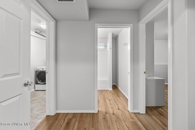 5735 E Steamboat Bnd, Post Falls, ID 83854 - hallway with washer / dryer and wood finished floors