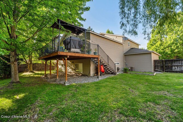 5735 E Steamboat Bnd, Post Falls, ID 83854 - rear view of property featuring stairs, a wooden deck, and a fenced backyard