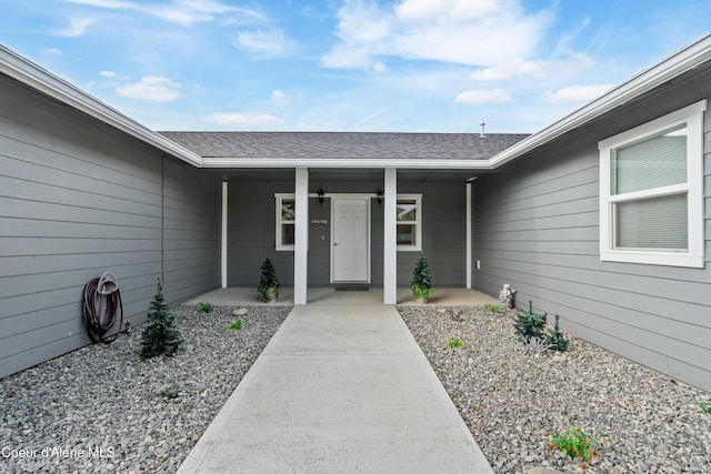 185 Leo Ln, Moyie Springs, ID 83845 - entrance to property with a shingled roof and covered porch