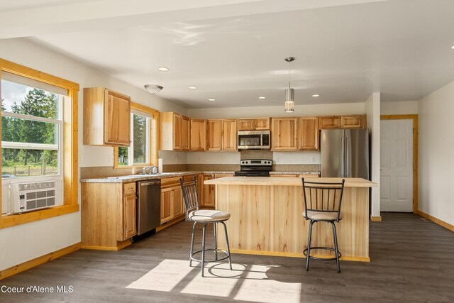 185 Leo Ln, Moyie Springs, ID 83845 - kitchen featuring stainless steel appliances, dark wood-style flooring, a kitchen island, a breakfast bar area, and recessed lighting