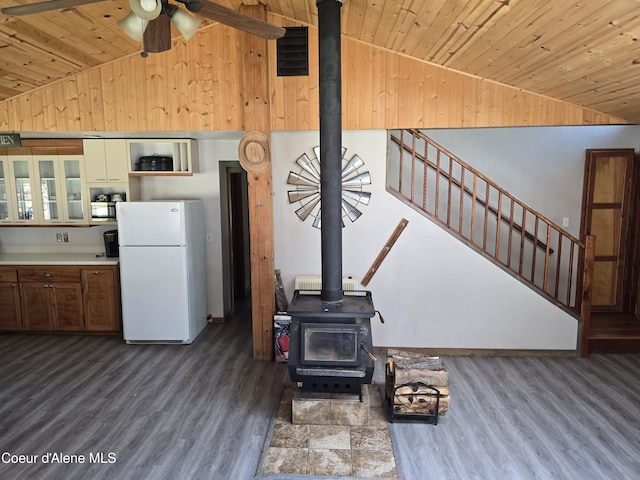 475 Old Range Rd, Clark Fork, ID 83811 - living area with lofted ceiling, a wood stove, ceiling fan, wood finished floors, and wooden ceiling