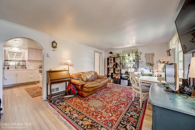 219 E 4th St, Oldtown, ID 83822 - living area with arched walkways and light wood-style flooring