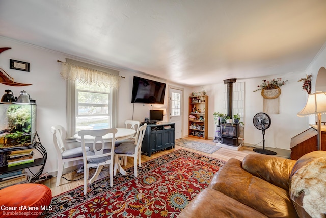 219 E 4th St, Oldtown, ID 83822 - living room with a wood stove, light wood-style floors, and crown molding
