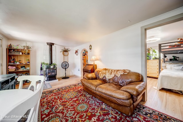 219 E 4th St, Oldtown, ID 83822 - living area featuring a wood stove, light wood-style floors, and crown molding