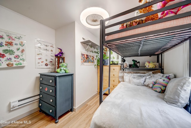 219 E 4th St, Oldtown, ID 83822 - bedroom featuring a baseboard heating unit and wood finished floors