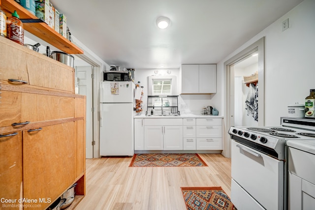 219 E 4th St, Oldtown, ID 83822 - kitchen featuring white appliances, light wood-type flooring, white cabinetry, and light countertops
