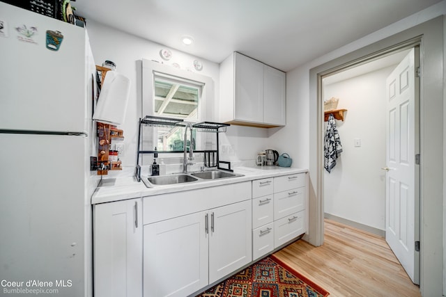 219 E 4th St, Oldtown, ID 83822 - kitchen featuring freestanding refrigerator, light countertops, white cabinetry, and light wood-type flooring