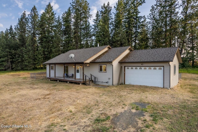 156 Promise Ln, Moyie Springs, ID 83845 - ranch-style home featuring a garage, a shingled roof, and dirt driveway
