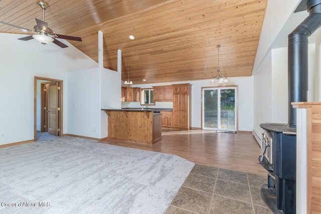 156 Promise Ln, Moyie Springs, ID 83845 - kitchen with a wood stove, open floor plan, wooden ceiling, high vaulted ceiling, and ceiling fan