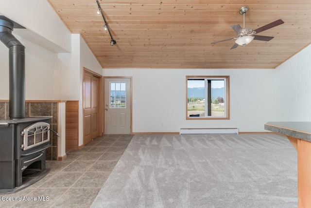 156 Promise Ln, Moyie Springs, ID 83845 - unfurnished living room with track lighting, wood ceiling, baseboard heating, vaulted ceiling, and a wood stove