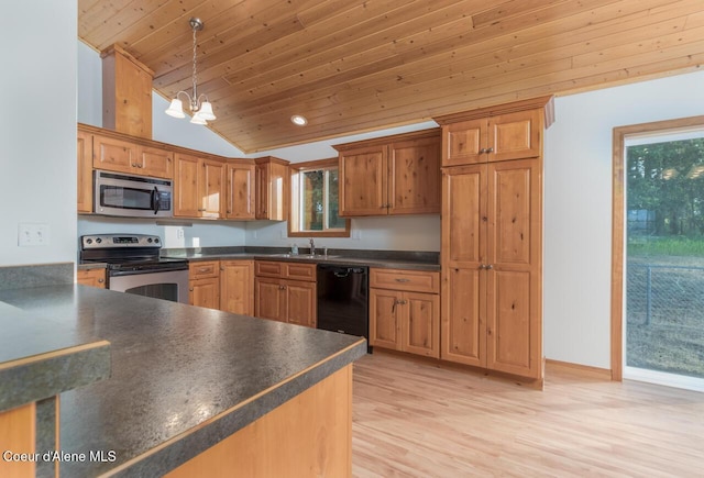 156 Promise Ln, Moyie Springs, ID 83845 - kitchen featuring stainless steel appliances, lofted ceiling, dark countertops, a chandelier, and light wood-type flooring