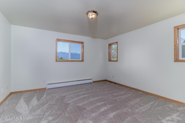 156 Promise Ln, Moyie Springs, ID 83845 - carpeted empty room featuring a baseboard radiator and plenty of natural light