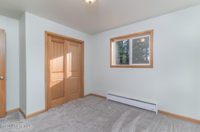 156 Promise Ln, Moyie Springs, ID 83845 - unfurnished bedroom featuring baseboard heating, carpet flooring, and a closet