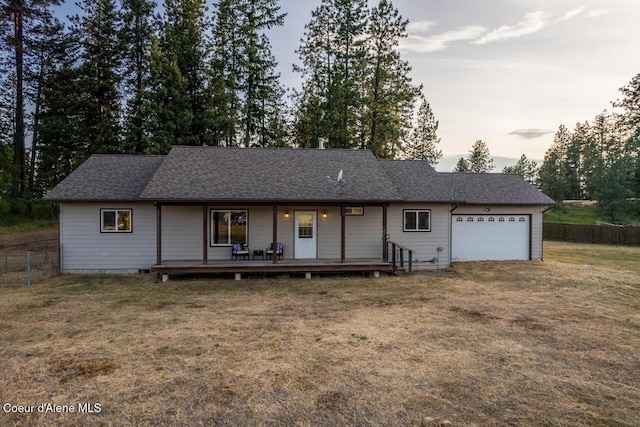 156 Promise Ln, Moyie Springs, ID 83845 - single story home with an attached garage, a porch, roof with shingles, and driveway