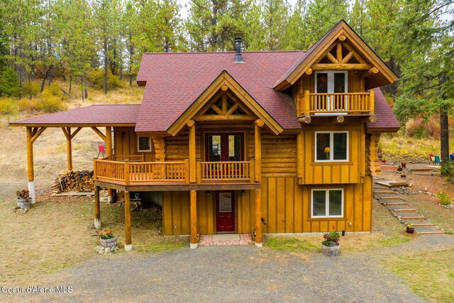26443 S Farup Rd, Worley, ID 83876 - log-style house with a balcony, board and batten siding, roof with shingles, and log siding